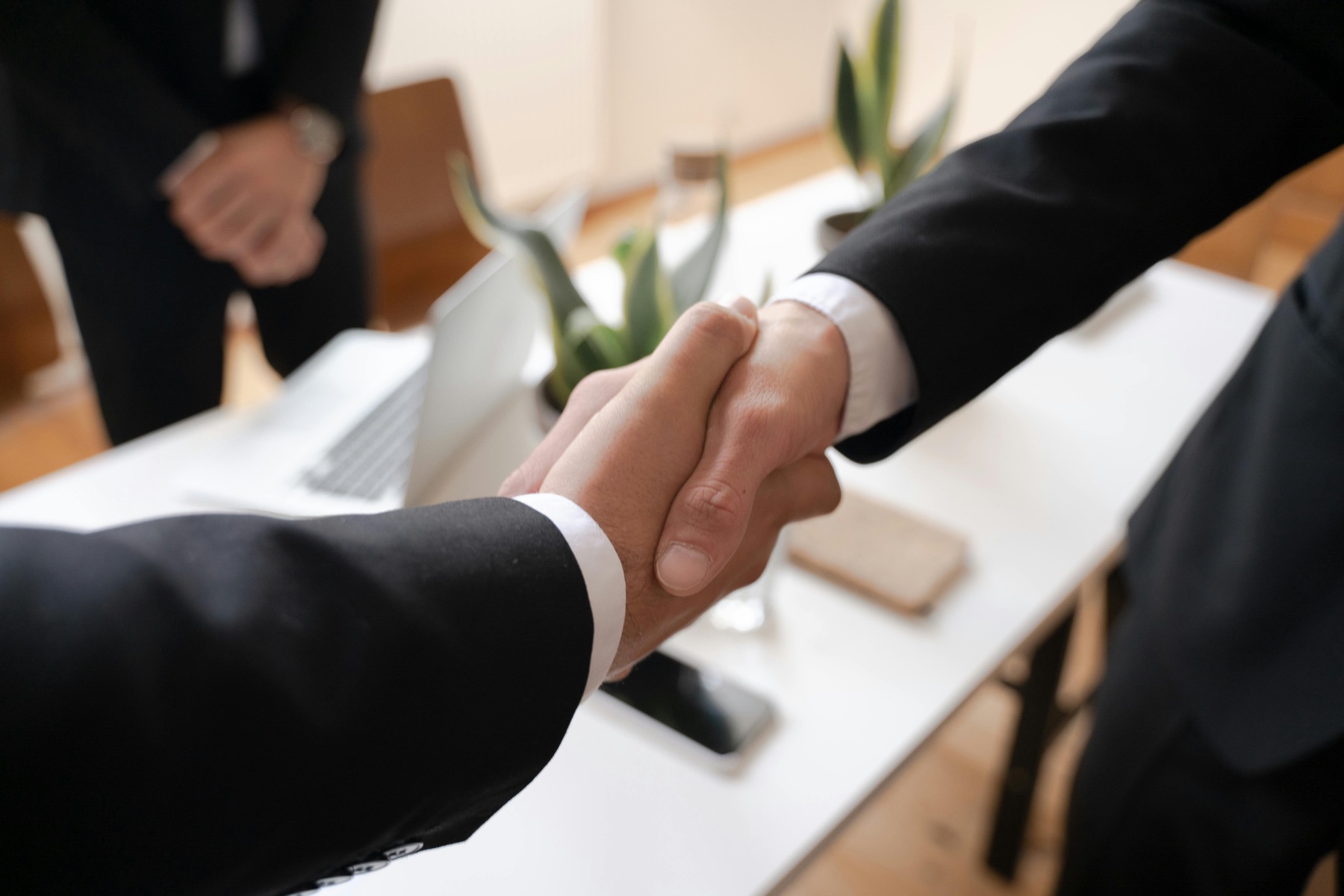 Business handshake across a meeting table
